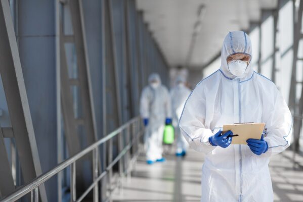 Head of medical workers reading rules how to disinfecting outdoor accommodation, blurred background, copy space